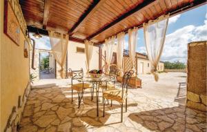 a patio with a table and chairs and a building at App,to Fiordaliso in Balestrate