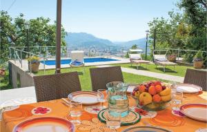 a table with a bowl of fruit on it with a view at Casa Fulvia in Camaiore