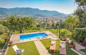 a backyard with a swimming pool and chairs at Casa Fulvia in Camaiore