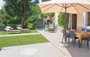 a patio with a table and an umbrella at Casa Fulvia in Camaiore