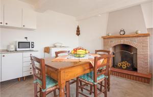 a dining room with a table and a fireplace at Casa Fulvia in Camaiore