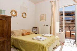 a bedroom with a bed with towels on it at Corfu Garitsa Spacious Apartment in Corfu