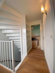 a hallway with stairs leading to the beach at Tussen Tulp & Zee in Noordwijk