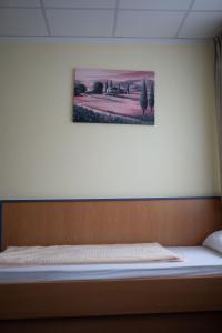 uma cama num quarto com uma fotografia na parede em RadlStadl - Brauhaus und Hotel em Kaarst