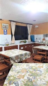 a room with two tables and a kitchen with a counter at La Estancia de Runtún Km 7 in Baños