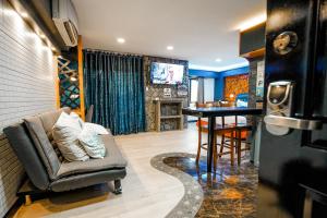 a living room with a couch and a table at CLOCKWORKORANGE Luxury Suites with Netflix in Mactan