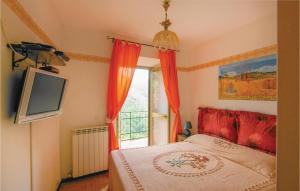 a bedroom with a bed and a tv and a window at Stunning Home In Montefegatesi With 4 Bedrooms And Wifi in Tereglio