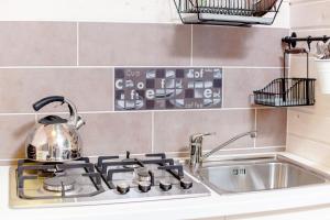 a tea kettle is sitting on a stove in a kitchen at Camping Pomona in Niechorze +13 photos
