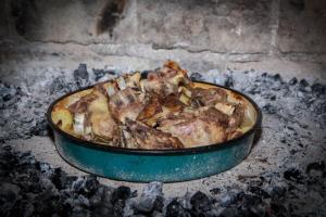 a pizza in a pan cooking in an oven at Apartment in Rakovica with balcony, air conditioning, Wi-Fi (601-2) in Rakovica