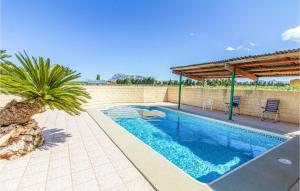 a swimming pool with a pavilion on a house at Nice Home In Denia With 4 Bedrooms, Outdoor Swimming Pool And Wifi in Denia