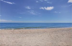 a sandy beach with the ocean in the background at Cozy Home In Villelongue in Villelongue-de-la-Salanque