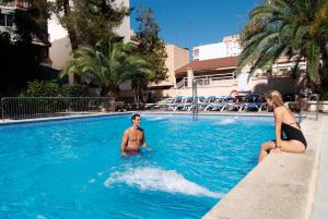 a woman in a bikini swimming in a pool at Piñero Tal in El Arenal