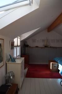 a attic room with a bed and a boat on the wall at 6 Trungle Terrace in Paul