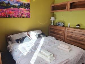 a bedroom with a bed with towels on it at Apartament Glinki in Bydgoszcz