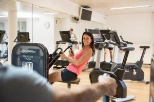 a woman riding on a treadmill in a gym at Vayamundo Oostende in Ostend