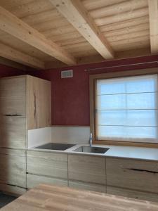 a kitchen with a sink and a window at Chalet Taulei in Valdidentro