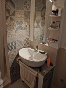 a bathroom with a sink and a mirror at The Nest / Il Nido in Polignano a Mare