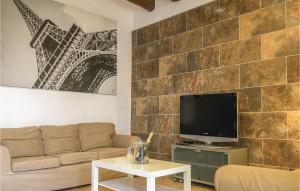 a living room with a couch and a flat screen tv at Awesome Apartment In Pineda De Mar With 3 Bedrooms And Wifi in Pineda de Mar