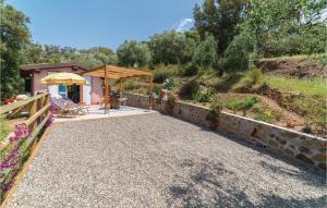 a house with a stone walkway and a patio at Laguna Celeste in Vetulonia