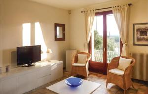 a living room with a flat screen tv and chairs at Pet Friendly Home In Cesseras With Outdoor Swimming Pool in Cesseras