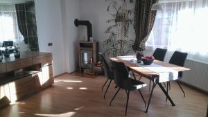 a table and chairs in a room with a kitchen at Appartement July in Innsbruck