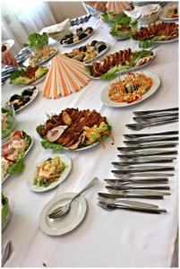 a table with many plates of food on it at Sztár Motel Étterem in Balassagyarmat