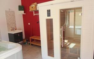 a bathroom with a large glass shower in a room at Nice Home In Narbonne With Sauna in Narbonne
