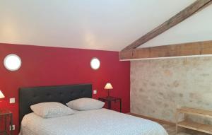 a bedroom with red walls and a bed with two pillows at Nice Home In Narbonne With Sauna in Narbonne