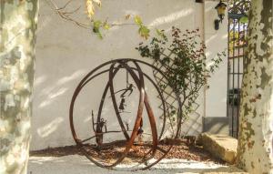 a metal sphere sitting in front of a building at Nice Home In Narbonne With Sauna in Narbonne