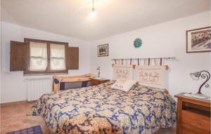 a bedroom with a bed and a desk and a window at Villa Antonietta in Oliena