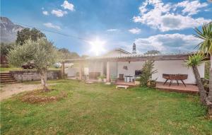 a white house with a bench in a yard at Villa Antonietta in Oliena