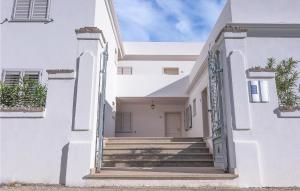 a white house with stairs in front of it at Bilo 4 in Orosei