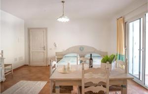 a dining room with a table and a bed at Bilo 4 in Orosei +4 photos