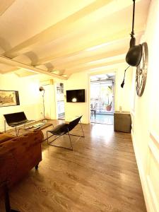 a living room with a couch and a clock on the wall at Rosselló Apartment in Barcelona