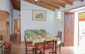 a dining room with a table and chairs at Awesome Home In Estellencs With House Sea View in Estellencs