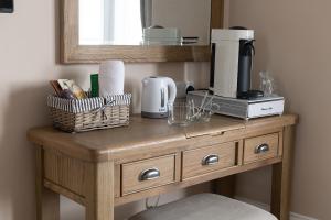 a wooden table with a coffee maker on top of it at Pebble House in Llandudno