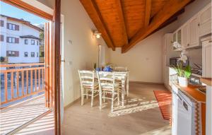 a kitchen with a table and chairs on a balcony at Beautiful Home In Fai Della Paganella With 2 Bedrooms And Wifi in Fai della Paganella