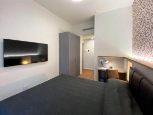 Televízia a/alebo spoločenská miestnosť v ubytovaní Villino Milano + 37 fotografií