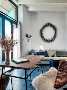 a living room with a table and a couch at Casa de Piedras by SIERRA VIVA desing in Cortelazor +13 photos
