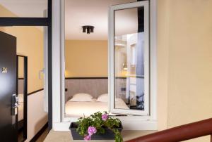 a mirror in a room with a bed at Hotel de l'Aqueduc in Paris +86 photos