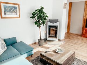 a living room with a couch and a fireplace at Ferienwohnung Olympia Axams in Innsbruck