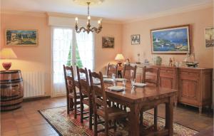 a dining room with a table and a wine barrel at Awesome Home In Ploneour-lanvern With 4 Bedrooms And Wifi in Plonéour-Lanvern