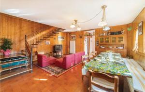 a dining room with a table and pink chairs at Panorama Sulle Dolomiti in SantʼAntonio Tortal