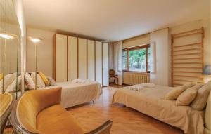a hotel room with two beds and a chair at Villa Silvana in Pesaro