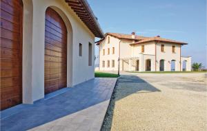 a house with two garage doors and a driveway at Narciso in Lamporecchio