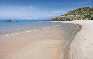 a beach with sand and the ocean on a sunny day at Lovely Home In Ca- With Wifi in Monte Nai