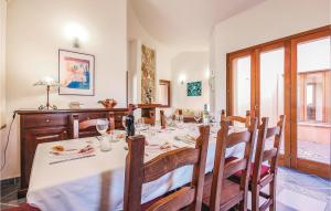 a dining room with a table with a white table cloth at Lovely Home In Ca- With Wifi in Monte Nai