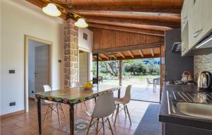 a kitchen and dining room with a table and chairs at Nice Home In Torranova With Kitchen in Torrenova