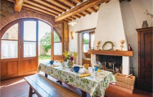 a living room with a table and a fireplace at Schivanoia 2 in Bagno Vignoni