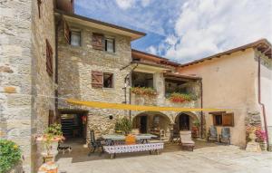 a stone building with a patio with a table at Casa Di Ettore in Comano